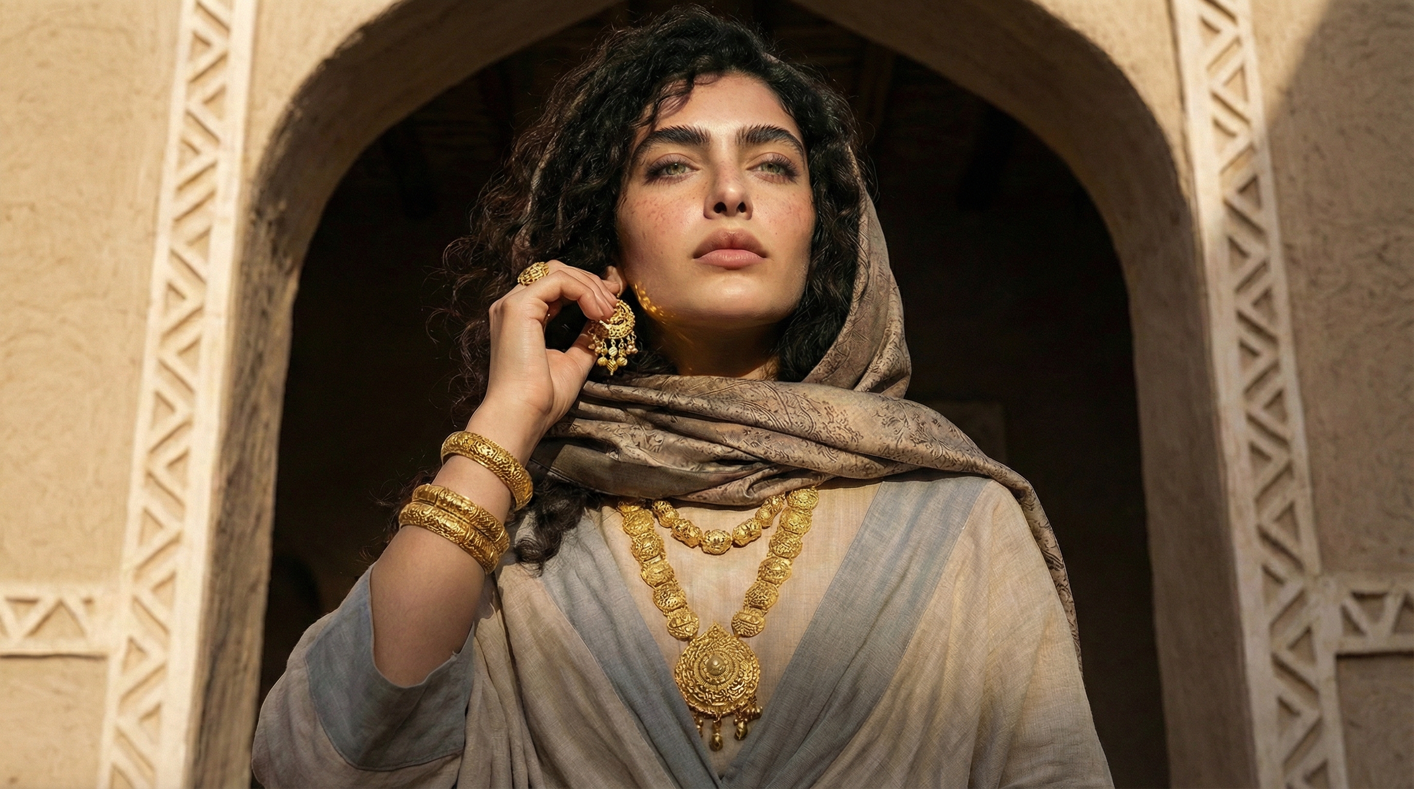 Gulf Heritage — woman holding a falcon, gold jewelry, Arabic architecture